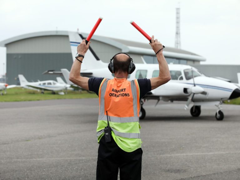 Person guiding plane at Solent Airport